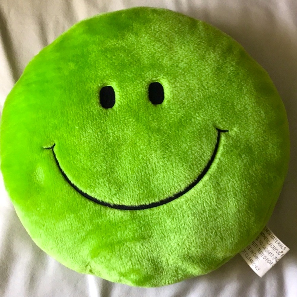 green smiley face pillow